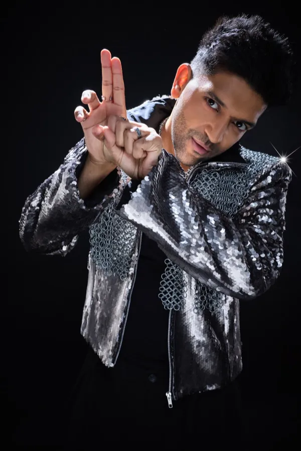 Guru Randhawa framing his face with his hands